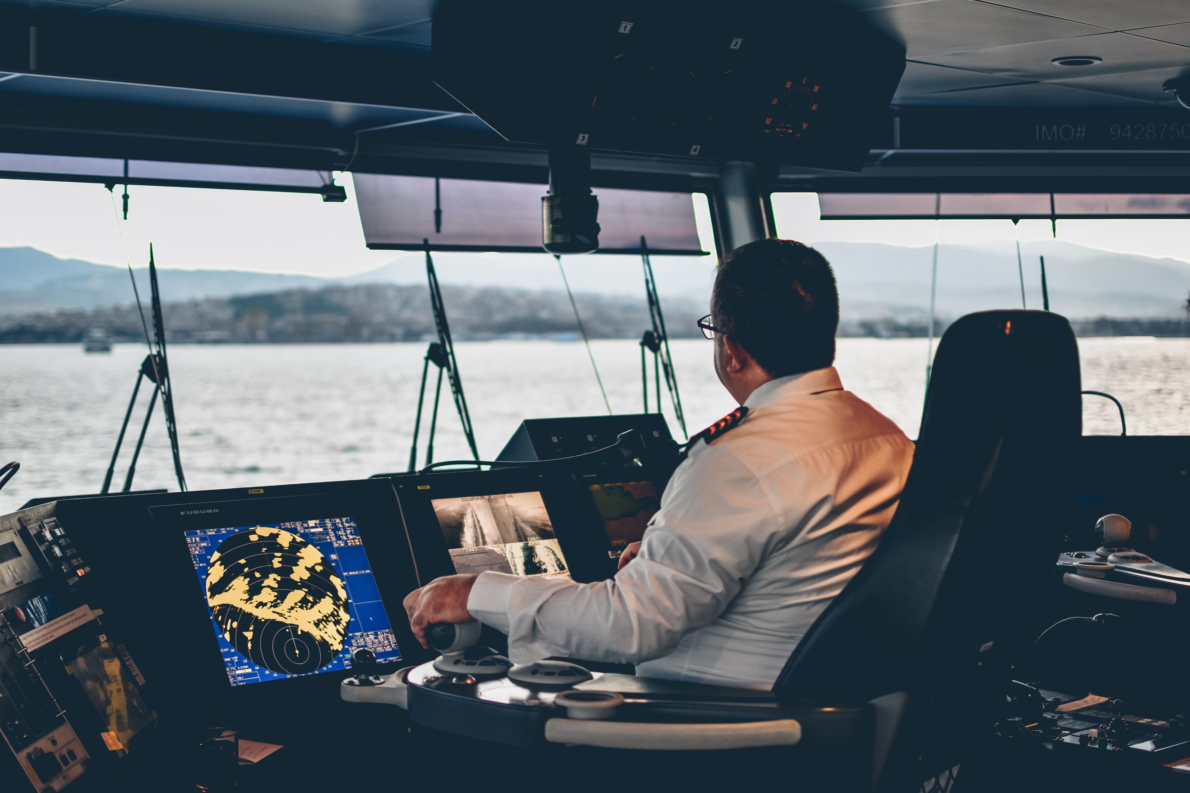 A captain controlling a cruise ferry from the cockpit in the afternoon..jpg